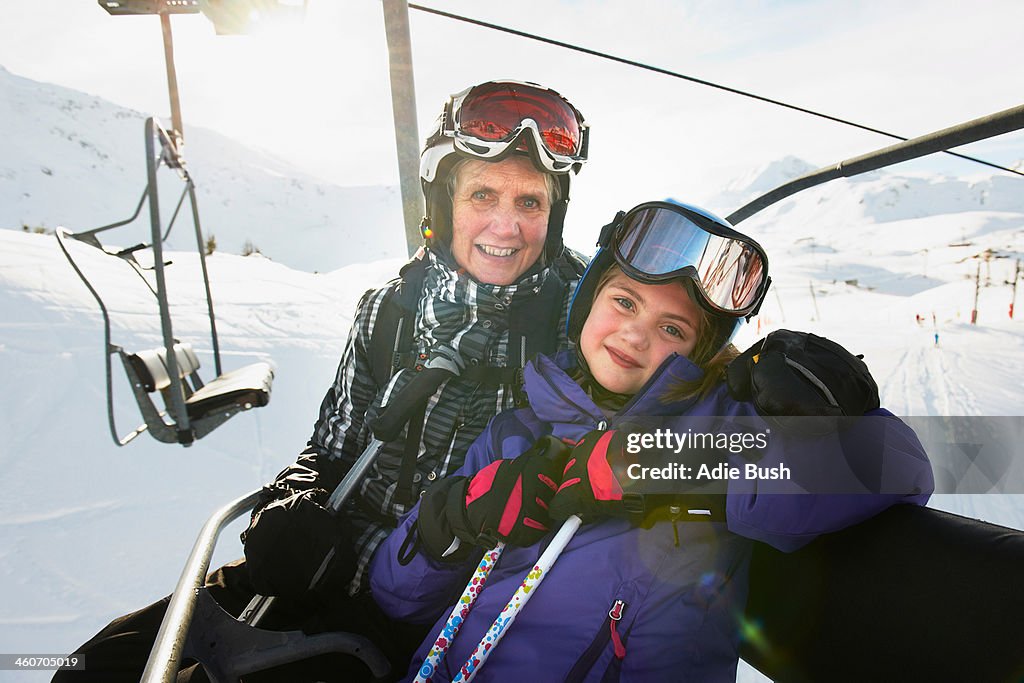 Portrait of grandmother and granddaughter on ski lift, Les Arcs, Haute-Savoie, France