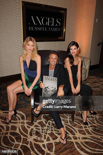 Martha Hunt, Russell James and Sara Sampaio attend "Angels" by Russell James fine-art photography exhibition at Seminole Hard Rock Hotel on December...