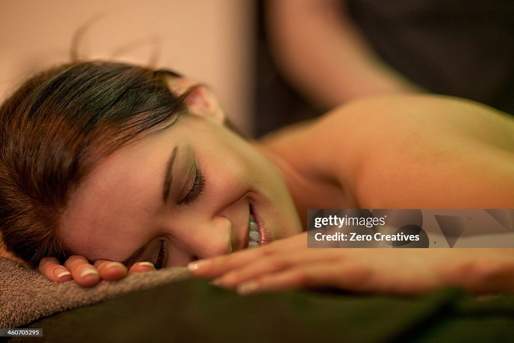 Close up of mid adult woman lying on massage table