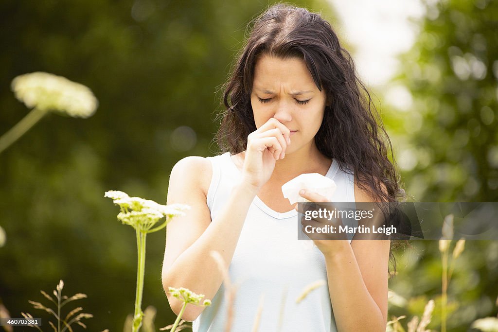 Girl with tissue rubbing nose
