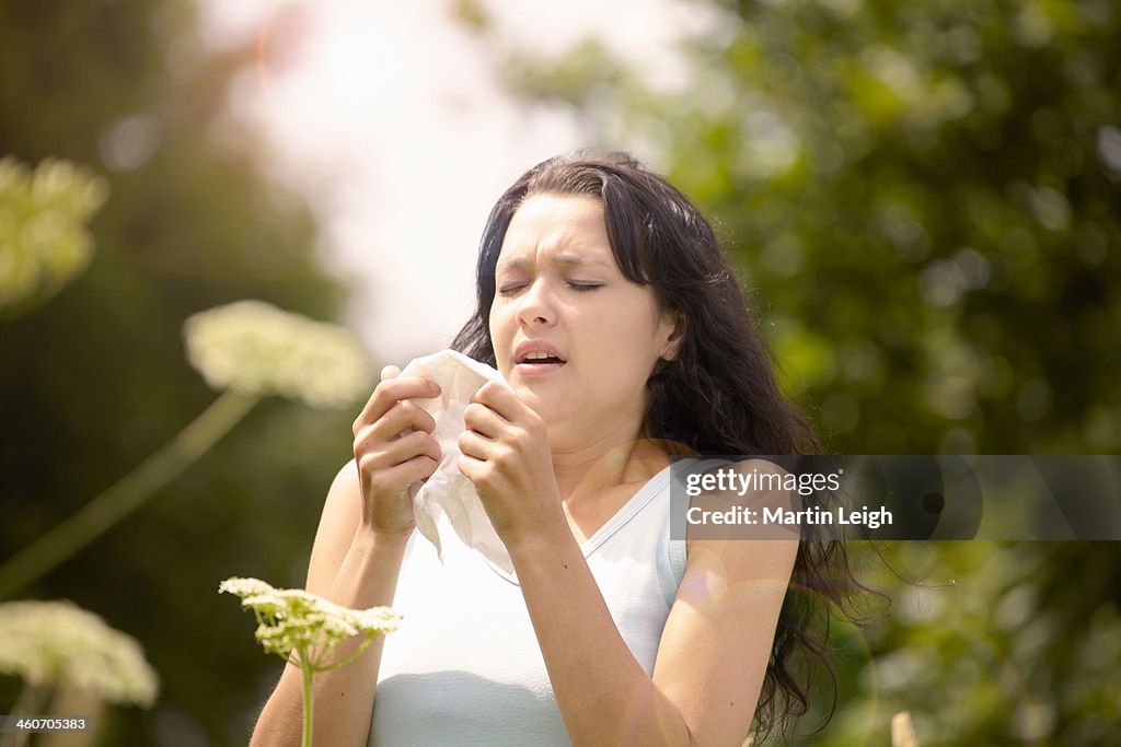 Girl about to sneeze into tissue