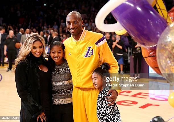 Kobe Bryant of the Los Angeles Lakers poses with wife Vanessa and daughters Gianna and Natalia during a ceremony honoring Bryant for moving into...