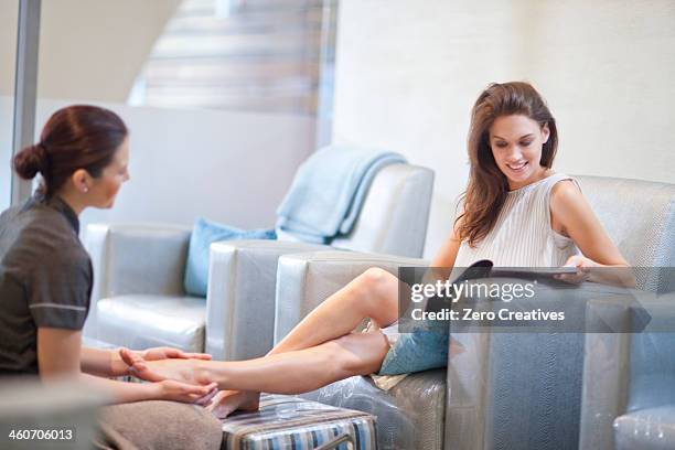 woman having feet massaged in spa treatment room - vest stock pictures, royalty-free photos & images