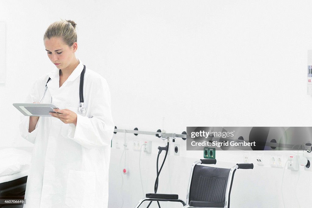 Female doctor using digital tablet