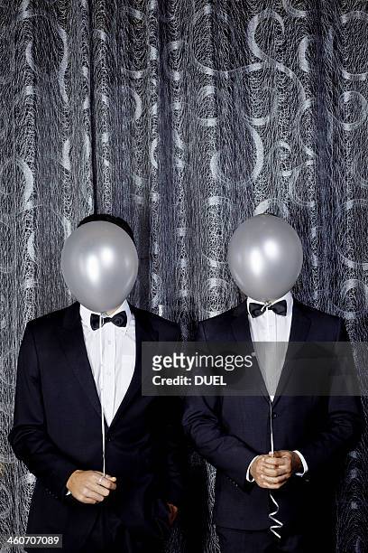 portrait of two young men with balloons in front of faces - lap dancing stockfoto's en -beelden
