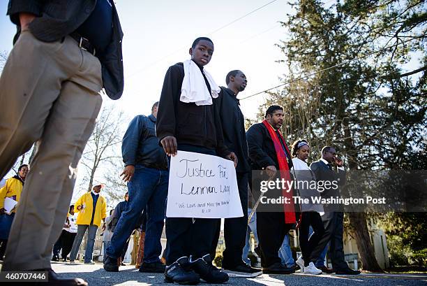 Davion Lacy leads a march with his brother, Pierre Lacy, NAACP North Carolina chapter president William Barber and his mother, Claudia Lacy, to honor...