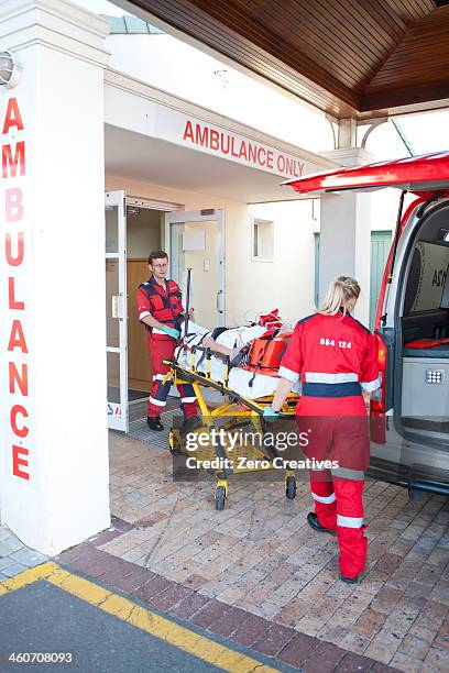 paramedics moving patient through hospital doorway - adrenaline stress stock pictures, royalty-free photos & images