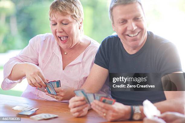 mature male playing cards with sister - card game mature people stock-fotos und bilder