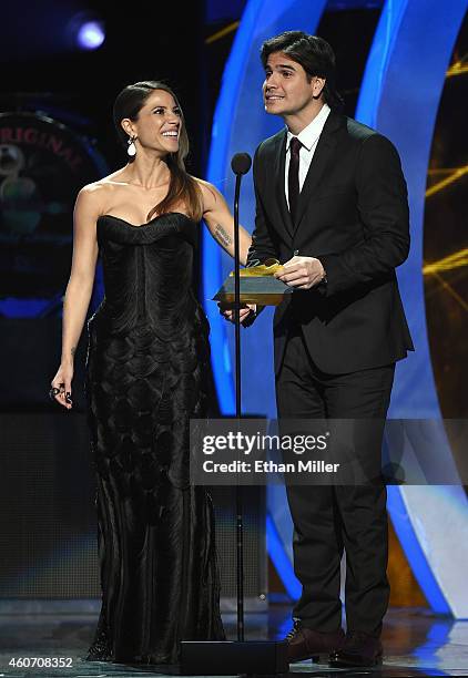 Recording artist Debi Nova and actor Daniel Arenas present an award during the 15th annual Latin GRAMMY Awards at the MGM Grand Garden Arena on...