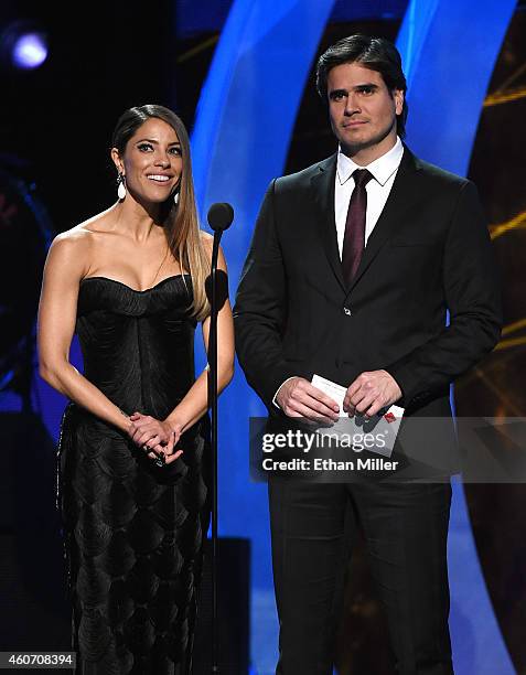 Recording artist Debi Nova and actor Daniel Arenas present an award during the 15th annual Latin GRAMMY Awards at the MGM Grand Garden Arena on...