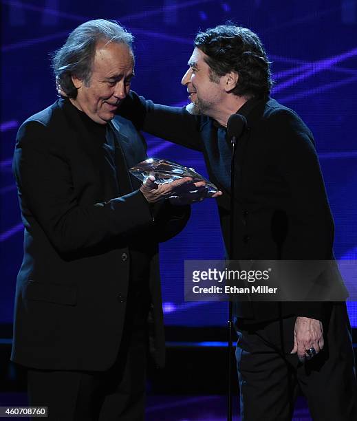 Recording artist Joan Manuel Serrat accepts the Person of the Year award from singer Joaquin Sabina during the 15th annual Latin GRAMMY Awards at the...