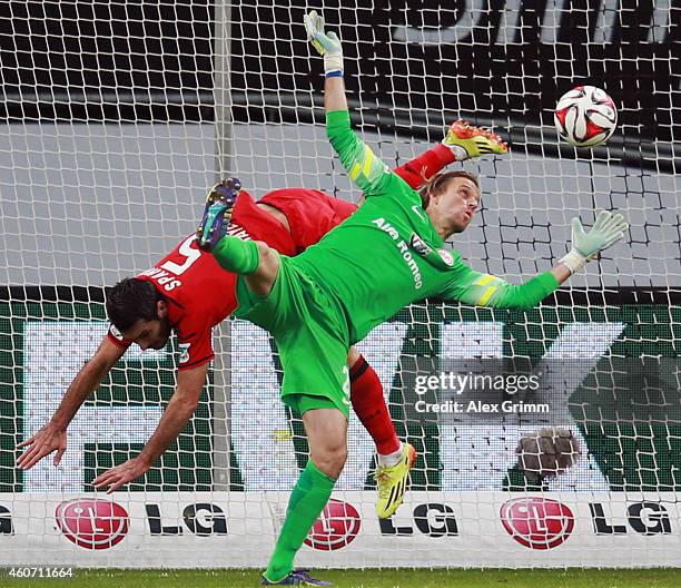 Emir Spahic of Leverkusen is challenged by goalkeeper Timo Hildebrand of Frankfurt during the Bundesliga match between Bayer 04 Leverkusen and...