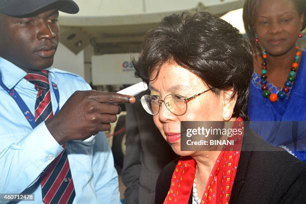 Margaret Chan, director general of the World Health Organization , has her temperature checked as she arrives in Conakry on December 20 during a tour...