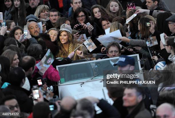 Miss France 2015 Camille Cerf poses for a photo with as she rides a car in Calais, northern France, during a ceremony for her return to her nearby...