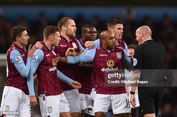 Aston Villa players surround Referee Lee Mason after Gabriel Agbonlahor of Aston Villa fouled Ashley Young of Manchester United during the Barclays...