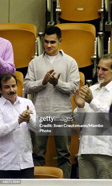 Fernando Gonzalez and Rene Gonzalez applaud to Elian Gonzalez as Cubas president Raul Castro mentioned Elian Gonzalez after finishing his speech at...