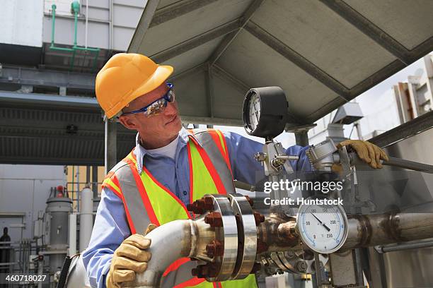 engineer examining transducer gauge at electric power plant - transducer stock pictures, royalty-free photos & images