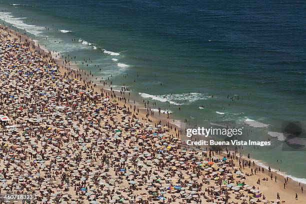 crowded beach - crowded beach stock pictures, royalty-free photos & images