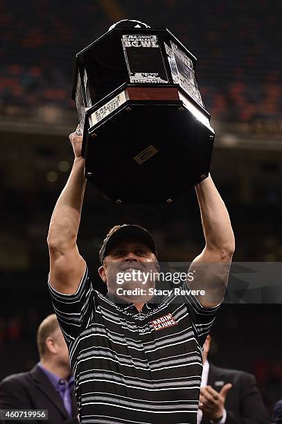 Head coach Mark Hudspeth of the Louisiana-Lafayette Ragin Cajuns raises the trophy following a victory over the Nevada Wolf Pack in the R&L Carriers...