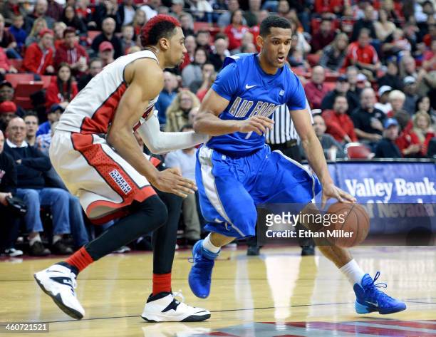 Kamryn Williams of the Air Force Falcons drives against against Khem Birch of the UNLV Rebels during their game at the Thomas & Mack Center on...