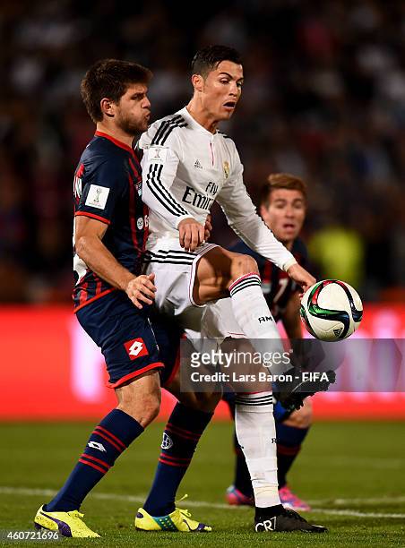 Walter Kannemann of San Lorenzo challenges Cristiano Ronaldo of Real Madrid during the FIFA Club World Cup Final between Real Madrid and San Lorenzo...