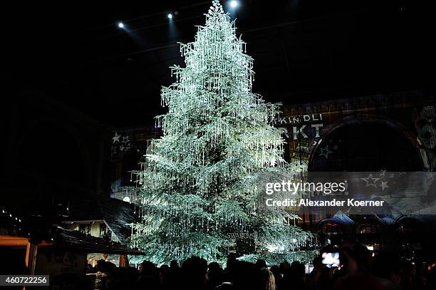 Members of the public walk by a huge christmas tree sponsored by Swarovski Jewelry, inside the Zurich main train station on December 20, 2014 in...