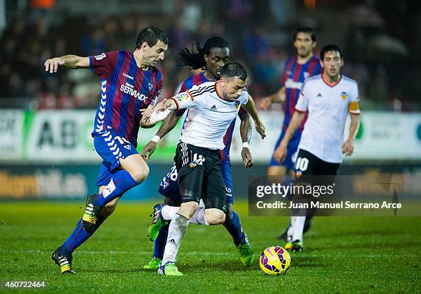 Javi Fuego of Valencia CF duels for the ball with Mikel Arruabarrena of SD Eibar during the La Liga match between SD Eibar and Valencia CF at Ipurua...