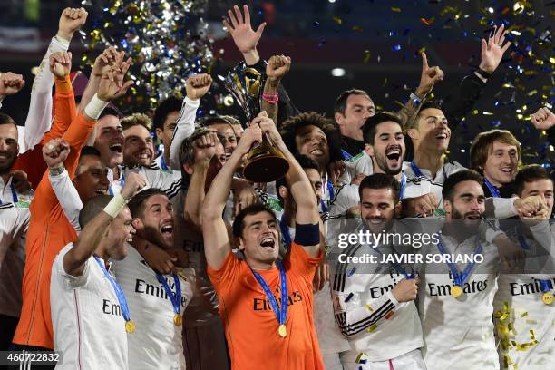 Real Madrid's players celebrate with the trophy after winning the FIFA Club World Cup final football match against San Lorenzo at the Marrakesh...