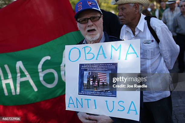 Antonio Rodriguez holds a sign that reads, " Obama Anti USA," as he joins with others opposed to U.S. President Barack Obama's announcement earlier...