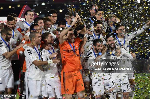 Real Madrid's players celebrate with the trophy after winning the FIFA Club World Cup final football match against San Lorenzo at the Marrakesh...