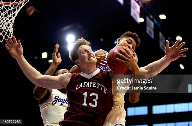 Matt Klinewski of the Lafayette Leopards battles Kelly Oubre Jr. #12 and Cliff Alexander of the Kansas Jayhawks for a rebound during the game at...