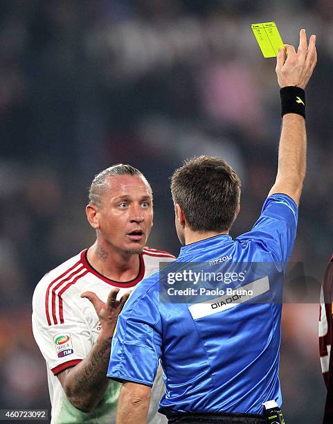 The referee Nicola Rizzoli shows the yellow card to Philippe Mexes of AC Milan during the Serie A match betweeen AS Roma and AC Milan at Stadio...