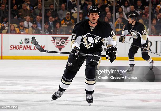 Craig Adams of the Pittsburgh Penguins skates against the Tampa Bay Lightning at Consol Energy Center on December 15, 2014 in Pittsburgh,...