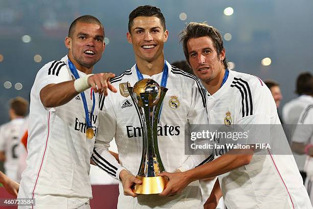 Pepe, Cristiano Ronaldo and Fabio Coentrao of Real Madrid celebrate with the trophy after the FIFA Club World Cup Final between Real Madrid and San...