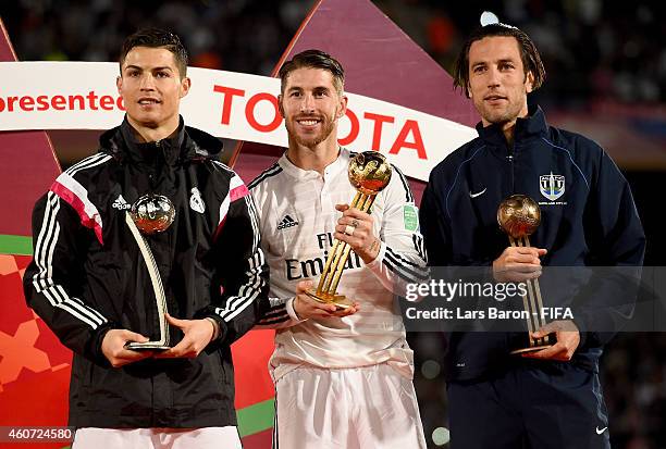 Cristiano Ronaldo of Real Madrid receives the adidas Silver Ball, Sergio Ramos of Real Madrid receives the adidas Golden Ball and Ivan Vicelich of...