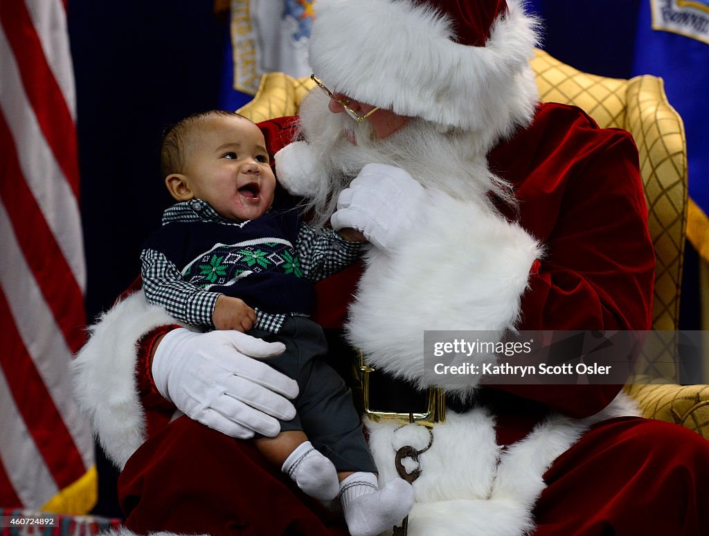 Santa and Mrs. Claus visit with service men and women and their families at Buckley Air Force Base on Friday, Dec. 19, 2014.