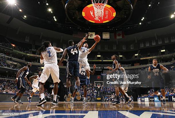 Pookie Powell of the Memphis Tigers drives to the basket for a layup against Albert Owens of the Oral Roberts Golden Eagles on December 20, 2014 at...