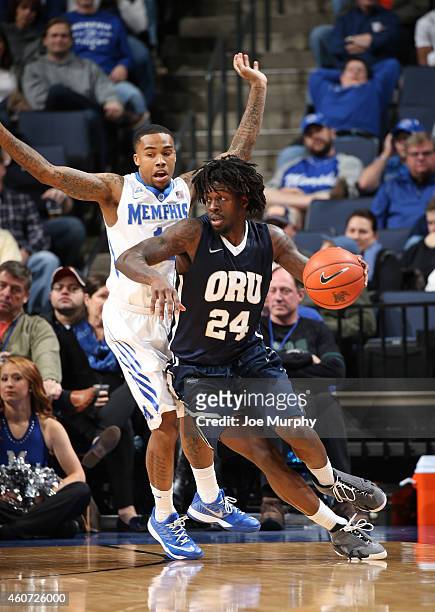 Korey Billbury of the Oral Roberts Golden Eagles drives with the ball against D'Marnier Cunningham of the Memphis Tigers on December 20, 2014 at...
