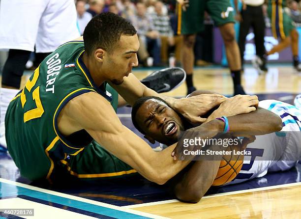Rudy Gobert of the Utah Jazz and Michael Kidd-Gilchrist of the Charlotte Hornets battle for a loose ball during their game at Time Warner Cable Arena...