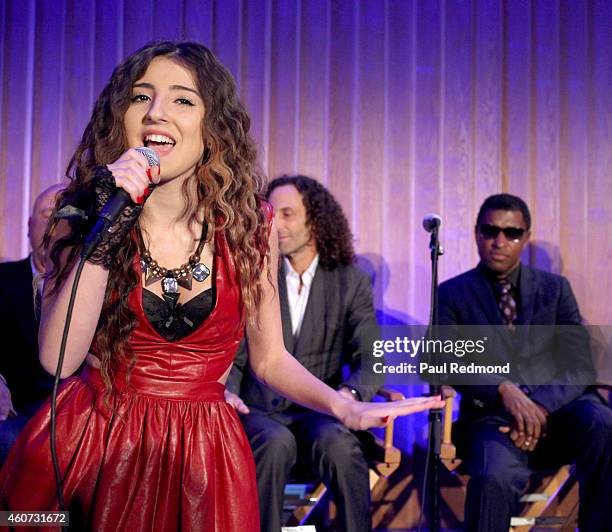 Musicians Kenny G and Kenny "Babyface" Edmonds watch singer Luara Melody perform at the ISINA collaboration announcement at Capitol Recording Studios...