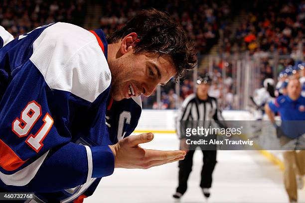 John Tavares of the New York Islanders reacts after taking a shot to the ear against the Tampa Bay Lightning during a game at the Nassau Veterans...