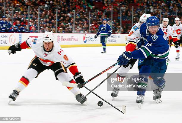 Dennis Wideman of the Calgary Flames reaches too redirect a pass from Alexandre Burrows of the Vancouver Canucks during their NHL game at Rogers...