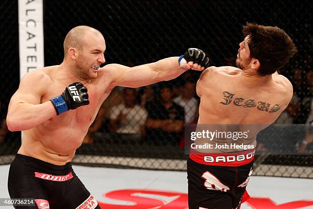 Patrick Cummins of the United States punches Antonio Carlos Junior of Brazil in their light heavyweight fight during the UFC Fight Night event inside...