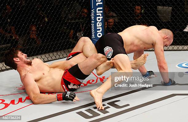 Antonio Carlos Junior of Brazil attempts to secure a leg lock submission against Patrick Cummins of the United States in their light heavyweight...