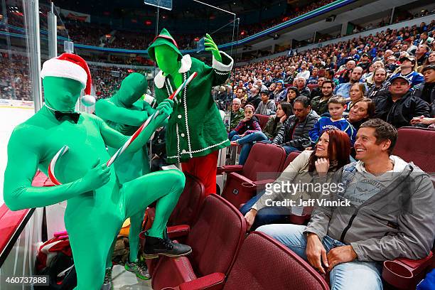 Jay DeMerit of the Vancouver Whitecaps FC makes a guest appearance with The Green Men during the NHL game between the Vancouver Canucks and the...