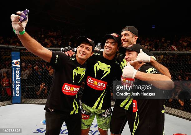 Lyoto Machida of Brazil takes a photo in the Octagon with his team after his TKO victory over CB Dollaway in their middleweight fight during the UFC...
