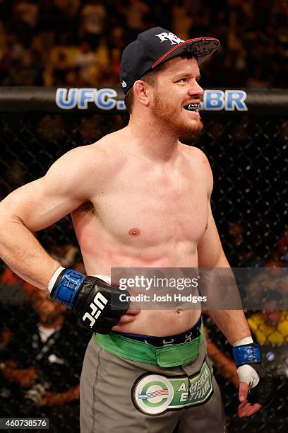 Dollaway of the United States clutches his side in pain after his TKO loss to Lyoto Machida of Brazil in their middleweight fight during the UFC...