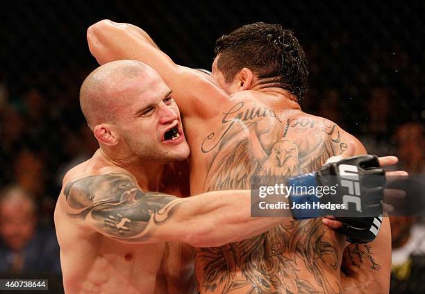 Mitch Gagnon of Canada attempts to take down Renan Barao of Brazil in their bantamweight fight during the UFC Fight Night event inside the Ginasio...