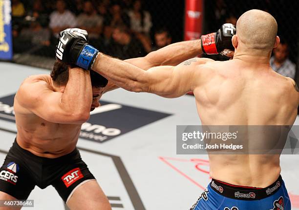 Renan Barao of Brazil and Mitch Gagnon of Canada trade punches in their bantamweight fight during the UFC Fight Night event inside the Ginasio Jose...