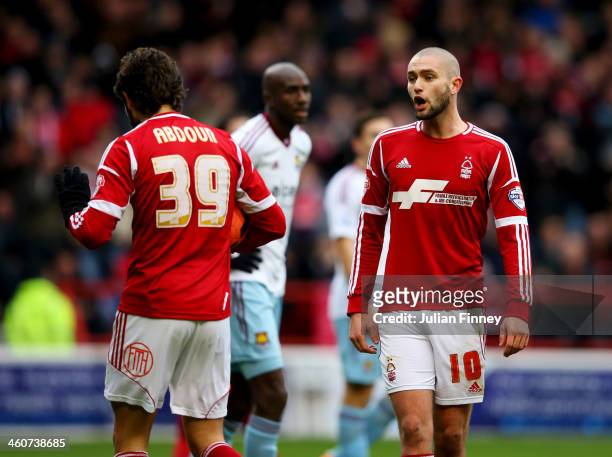 Henri Lansbury of Nottingham Forest argues with team mate Djamel Abdoun prior to a penalty kick being taken during the FA Cup with Budweiser Third...
